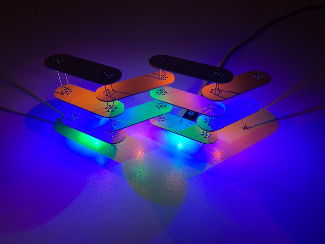 Moduli: a modular LED light comprised of only one single base unit. Many different structures can be formed through different assemblies of the units. The white PCBs reflect the coloured LED lights, mixing their colours in the proces. PCB design by me.