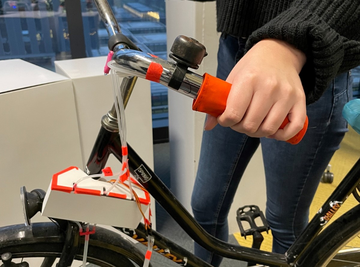 The Haptic Handlebar system installed on a bike, with a potential user holding the interface.